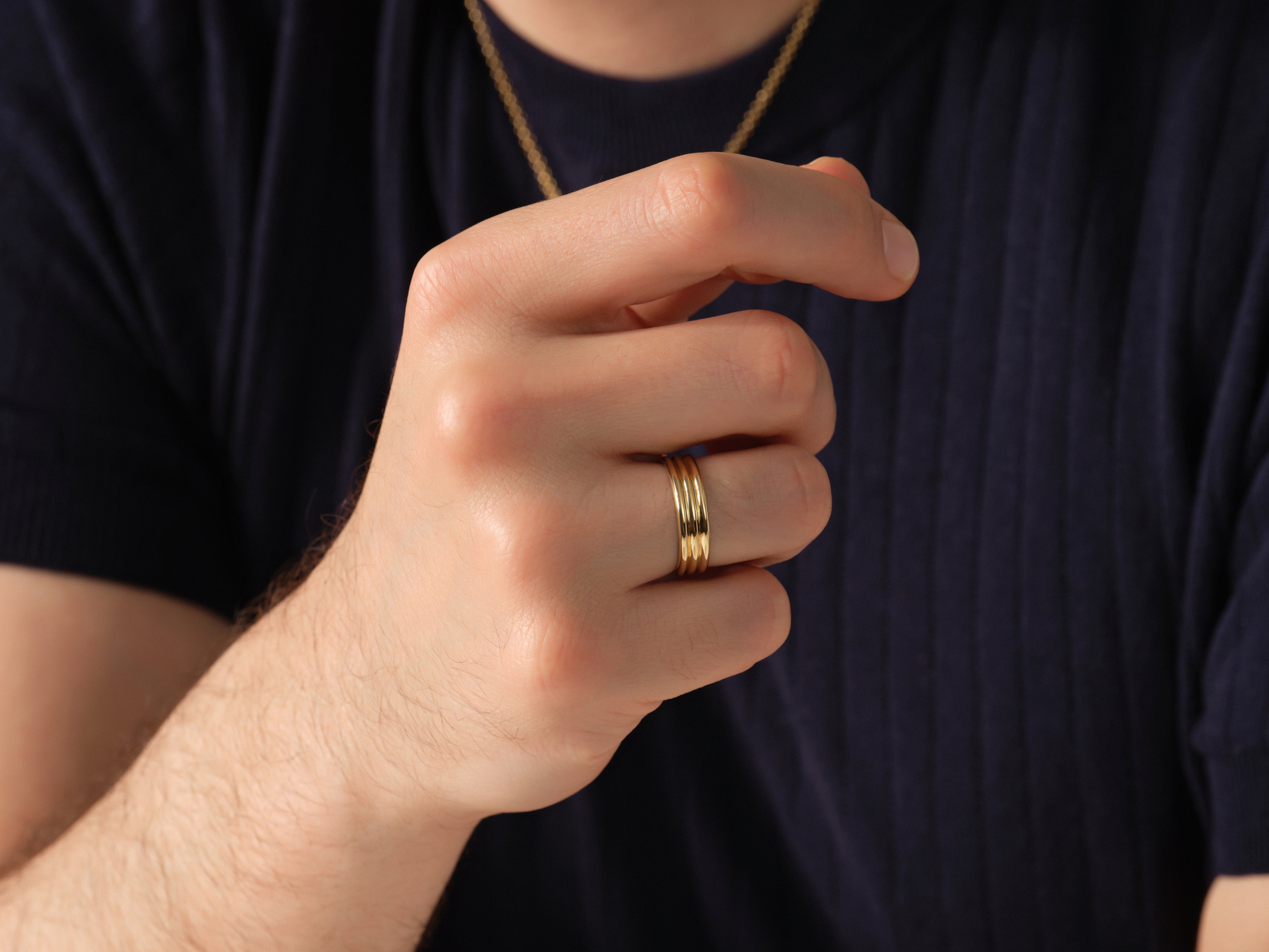 Gold triple band ring on a man's finger, jewelry