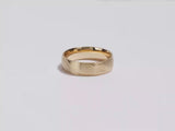 A video showing a yellow gold 6mm diagonal lined men's gold wedding band spinning on a white background.