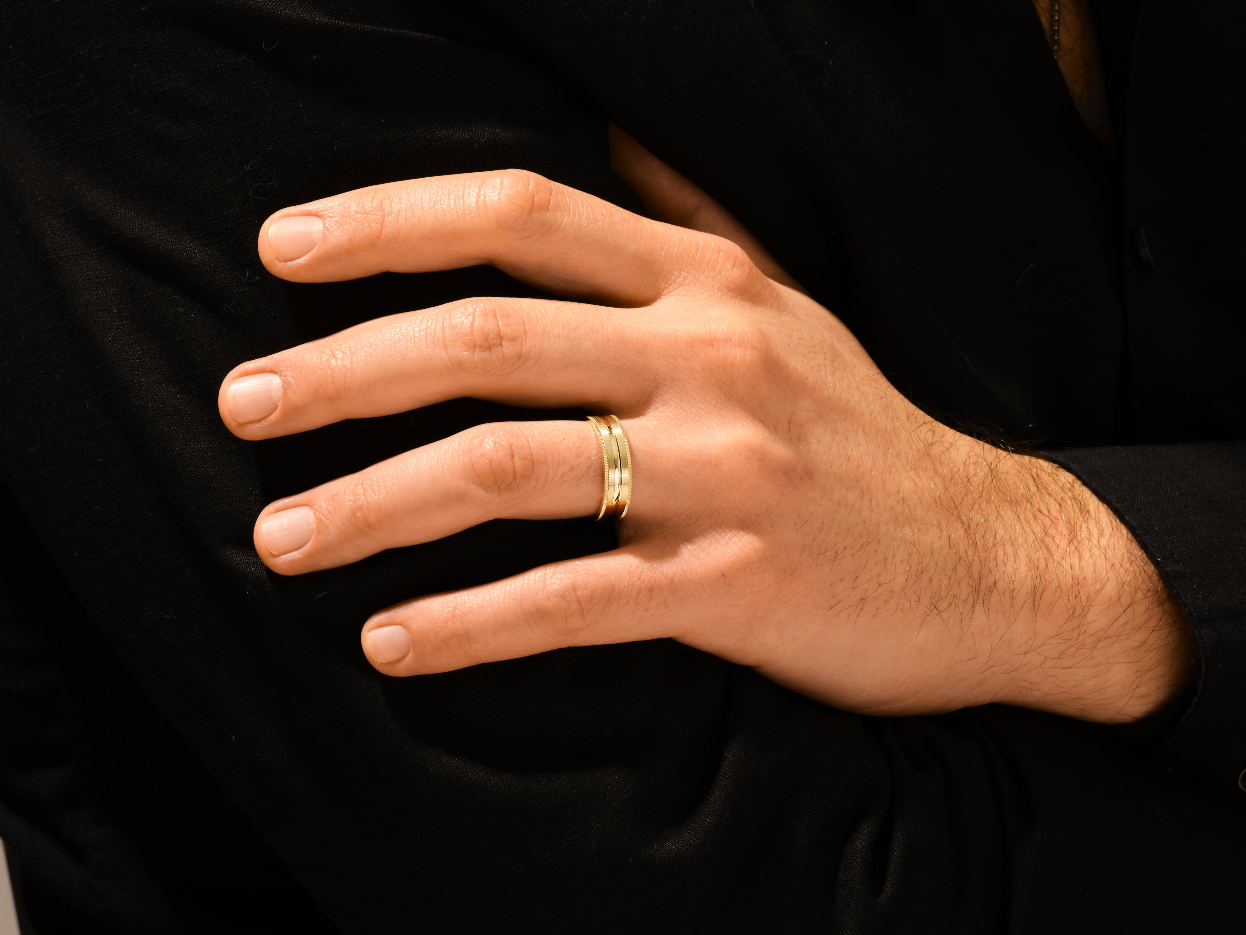 Gold band ring on a man's finger, jewelry for men