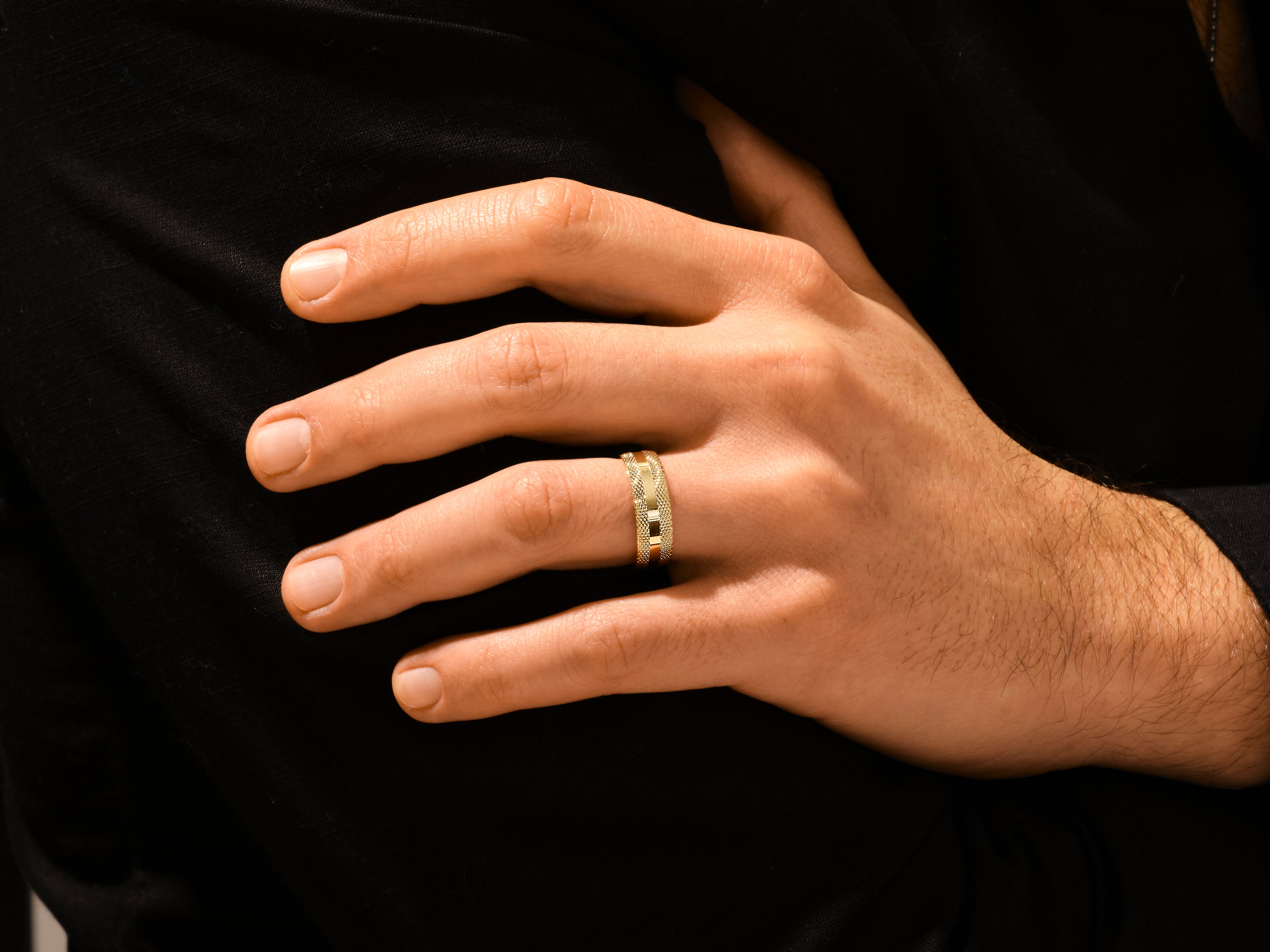 Men's textured gold ring on hand, luxury jewelry