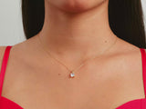 A video of a women model showing a yellow gold cushion cut moissanite solitaire pendant on her neck