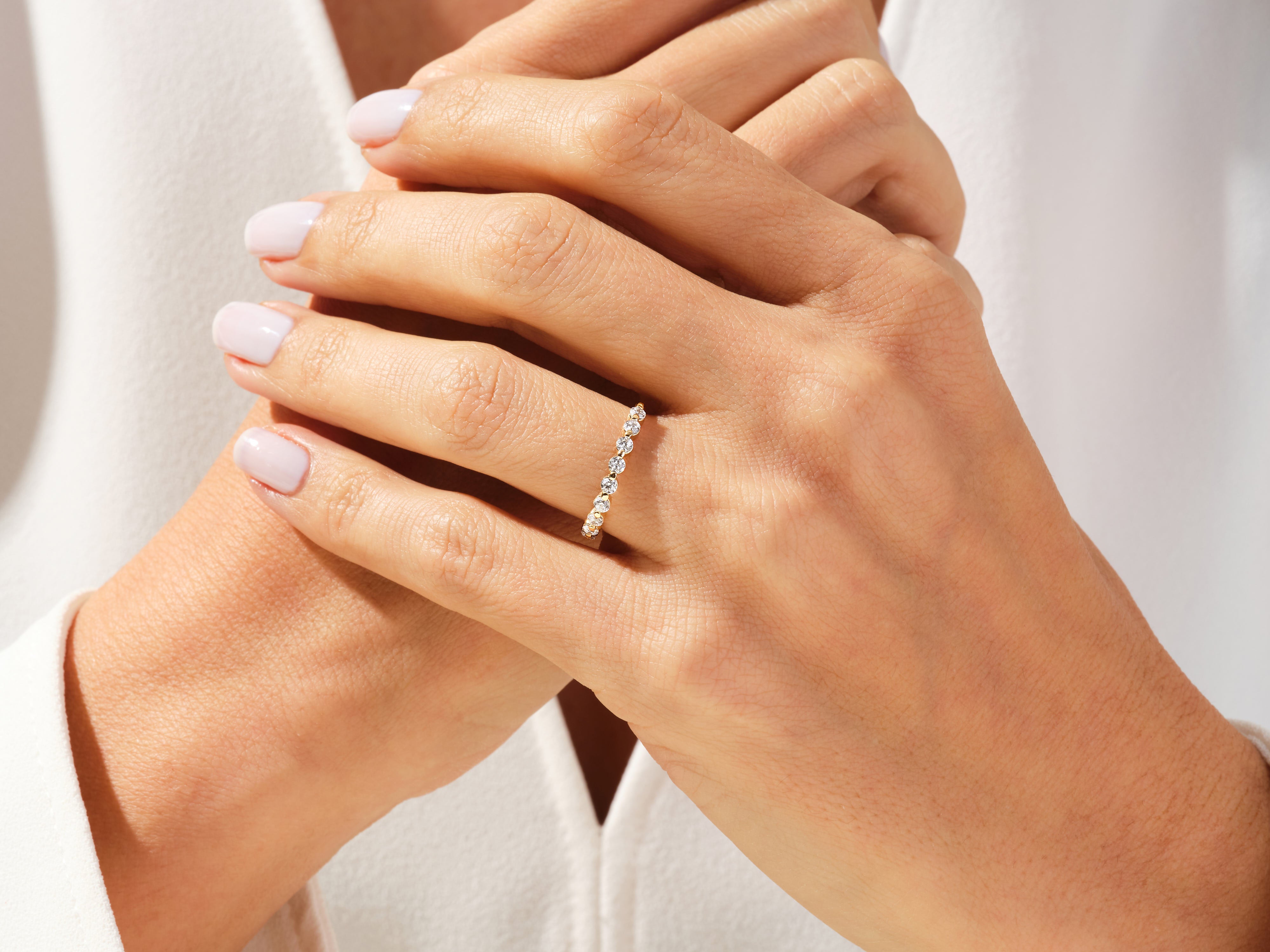 Diamond band ring on a woman's hand, jewelry product photography