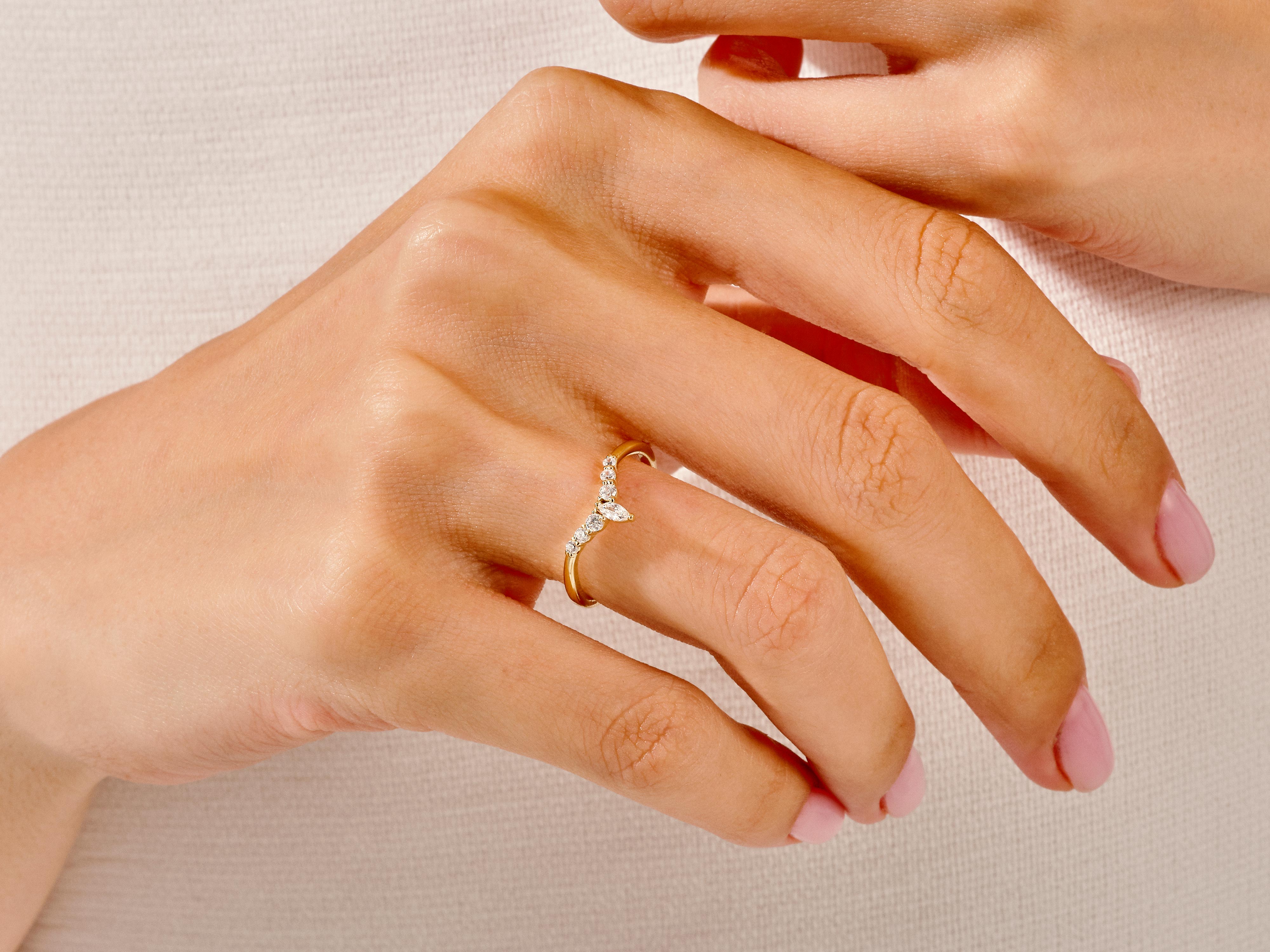 Gold diamond ring on a woman's hand, jewelry product