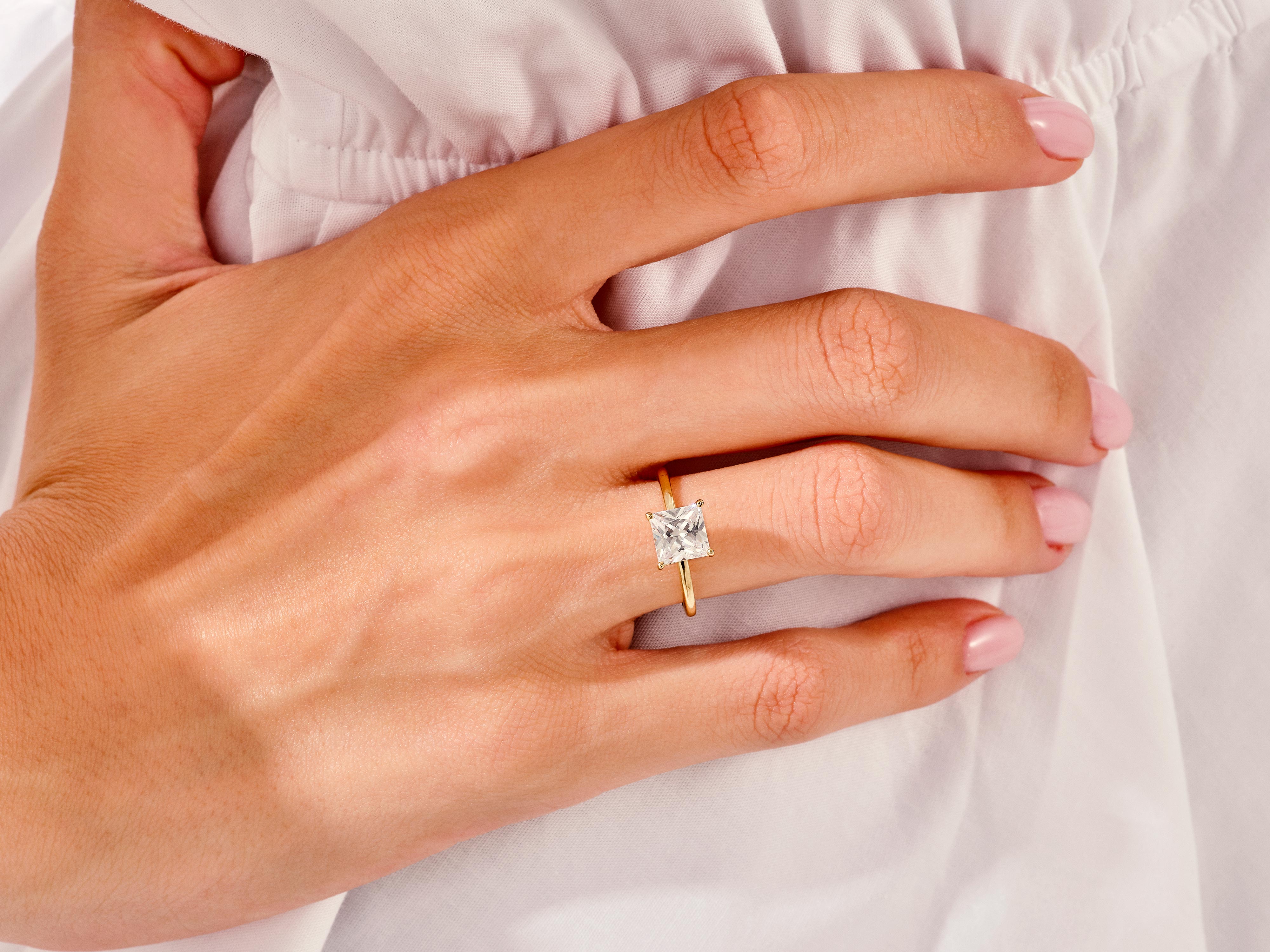 Princess cut diamond ring on a woman's hand