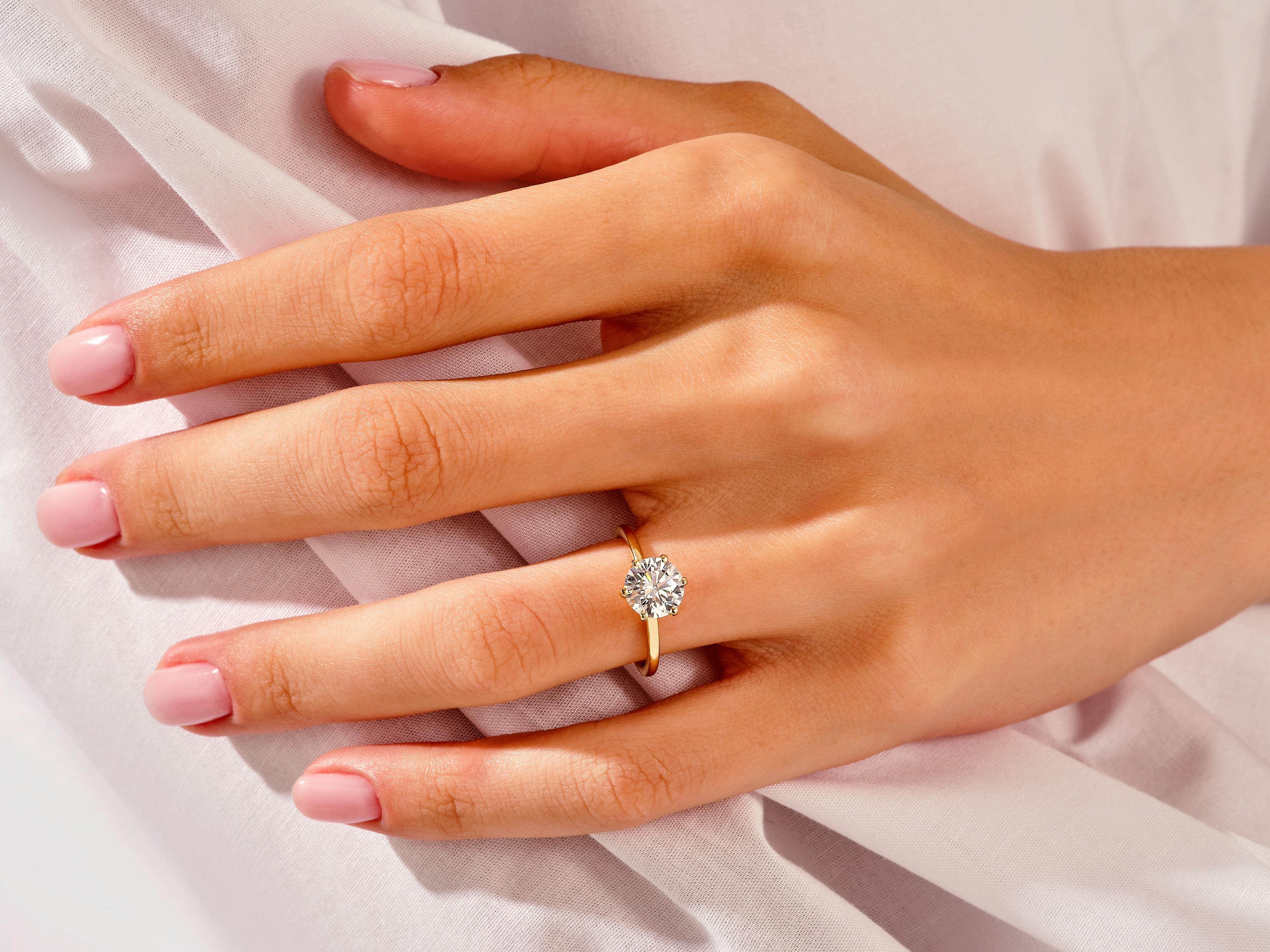 Diamond engagement ring on a woman's hand, jewelry product