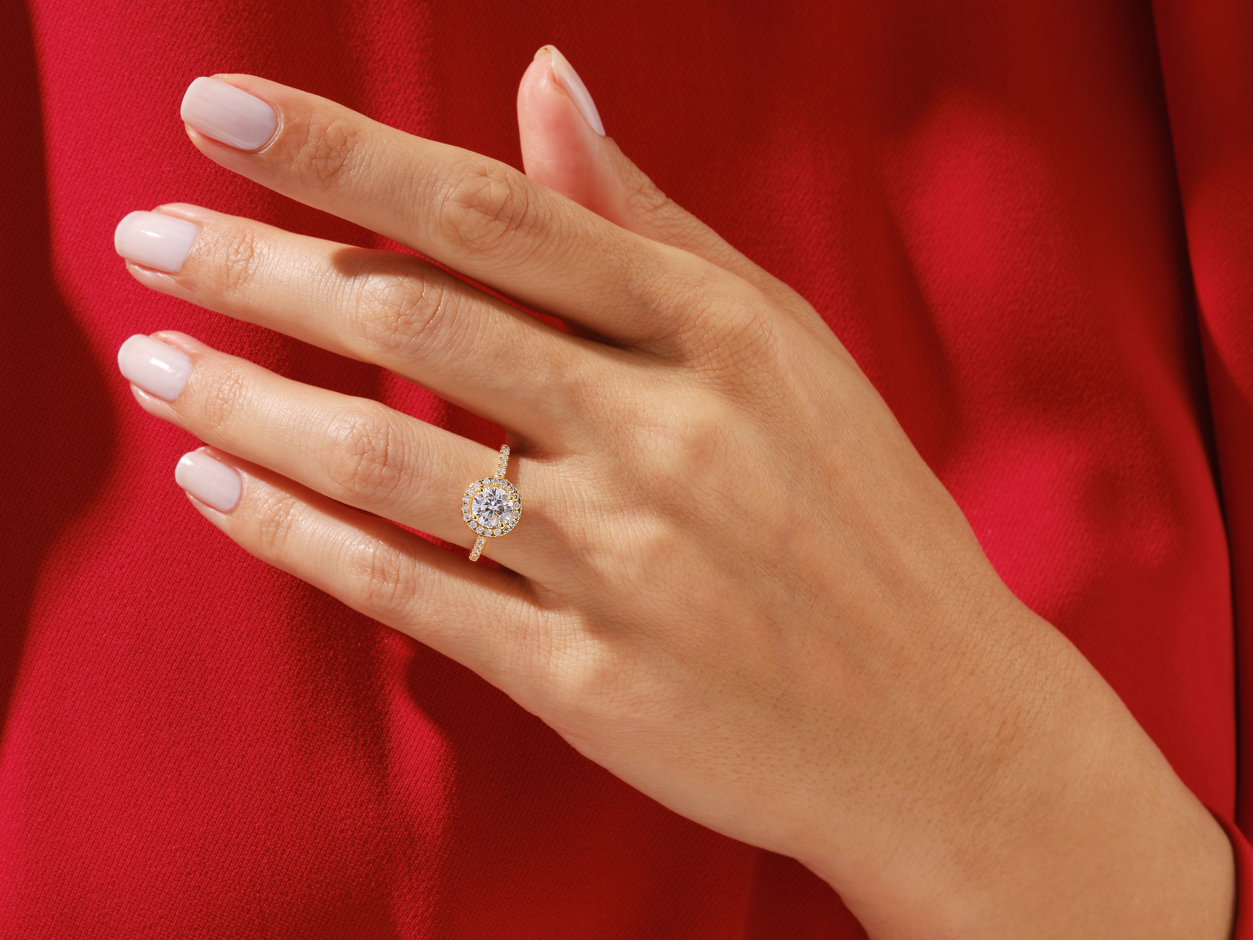 Diamond halo engagement ring on a hand, jewelry