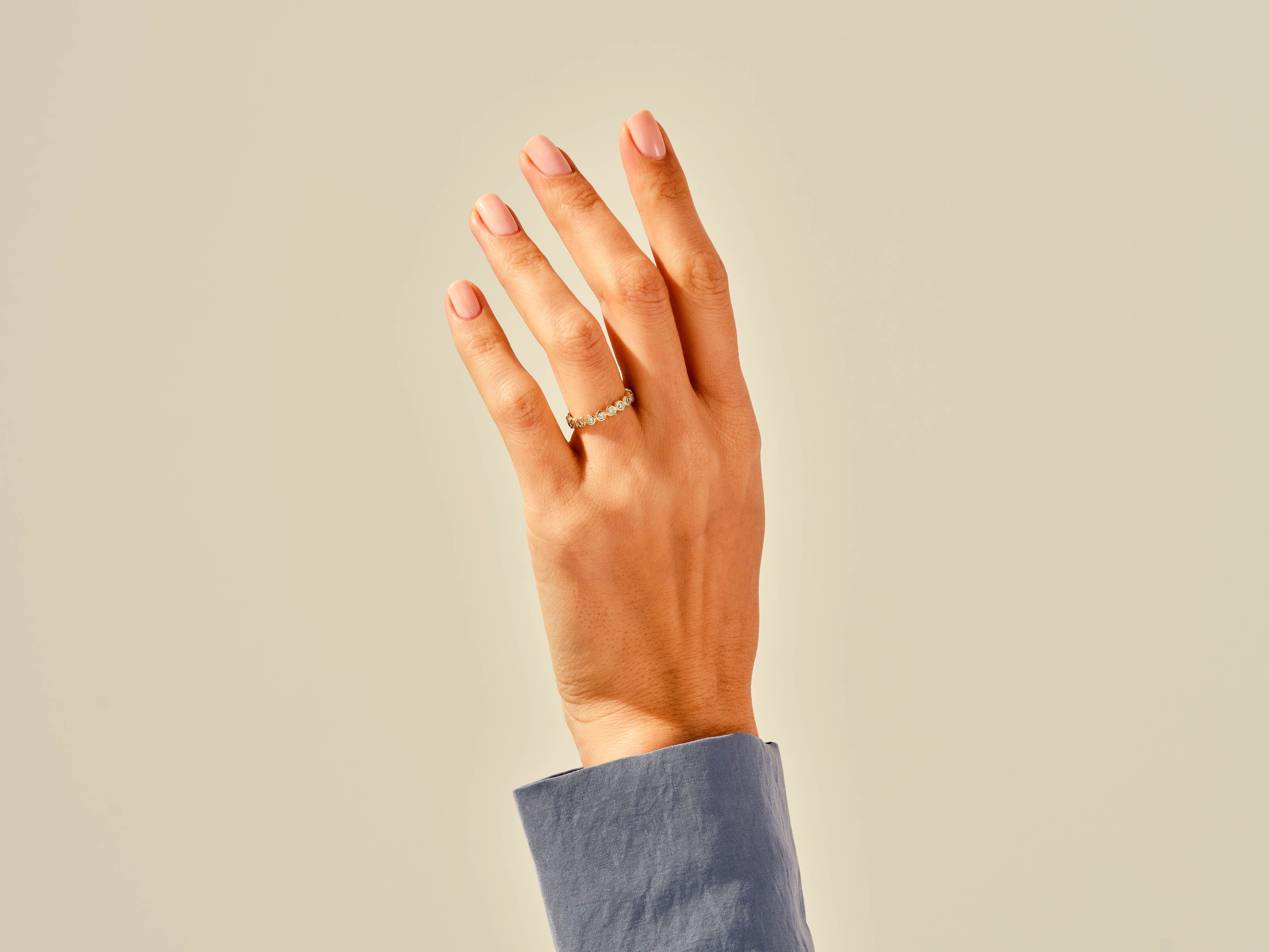 Diamond eternity band on a hand, jewelry photography