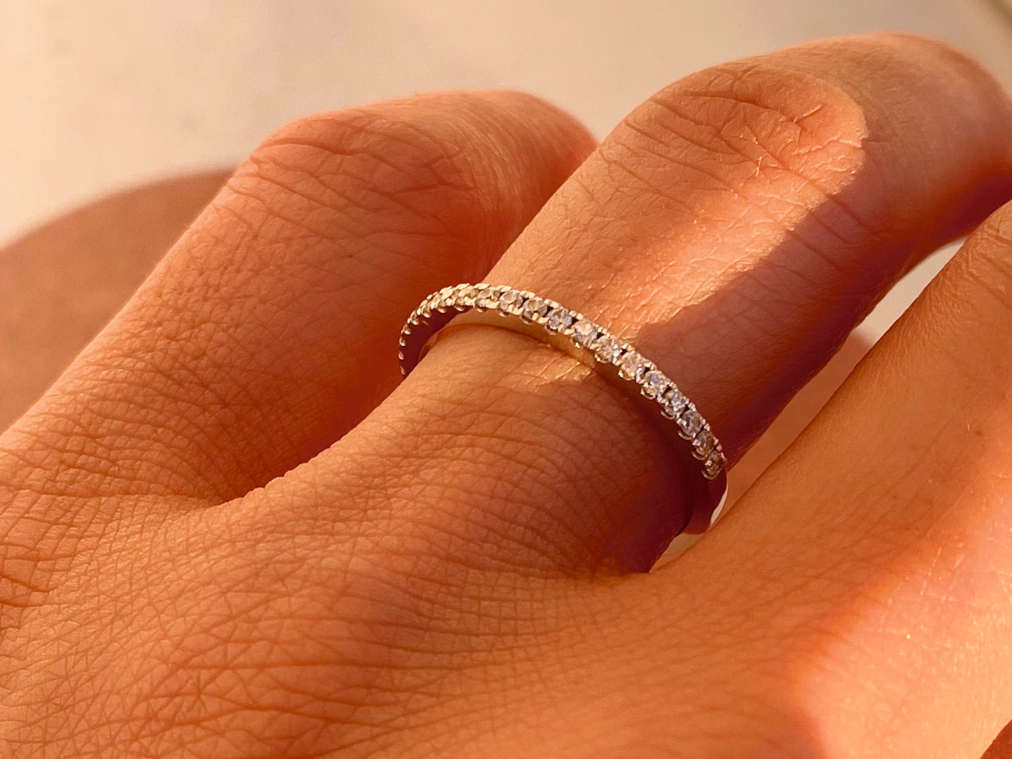 Diamond eternity ring on finger, fine jewelry for women