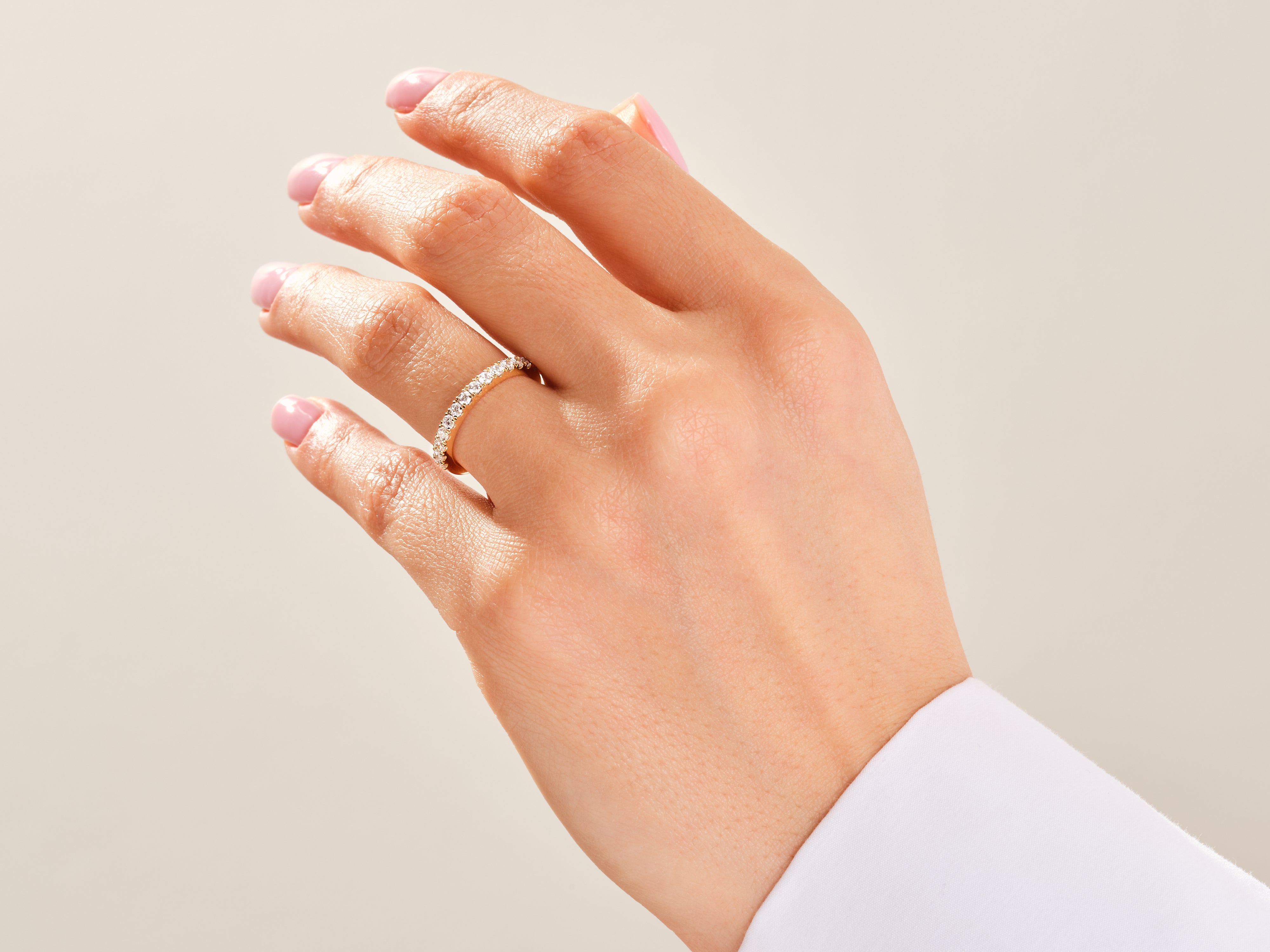 Diamond band ring on a woman's finger, jewelry product photography