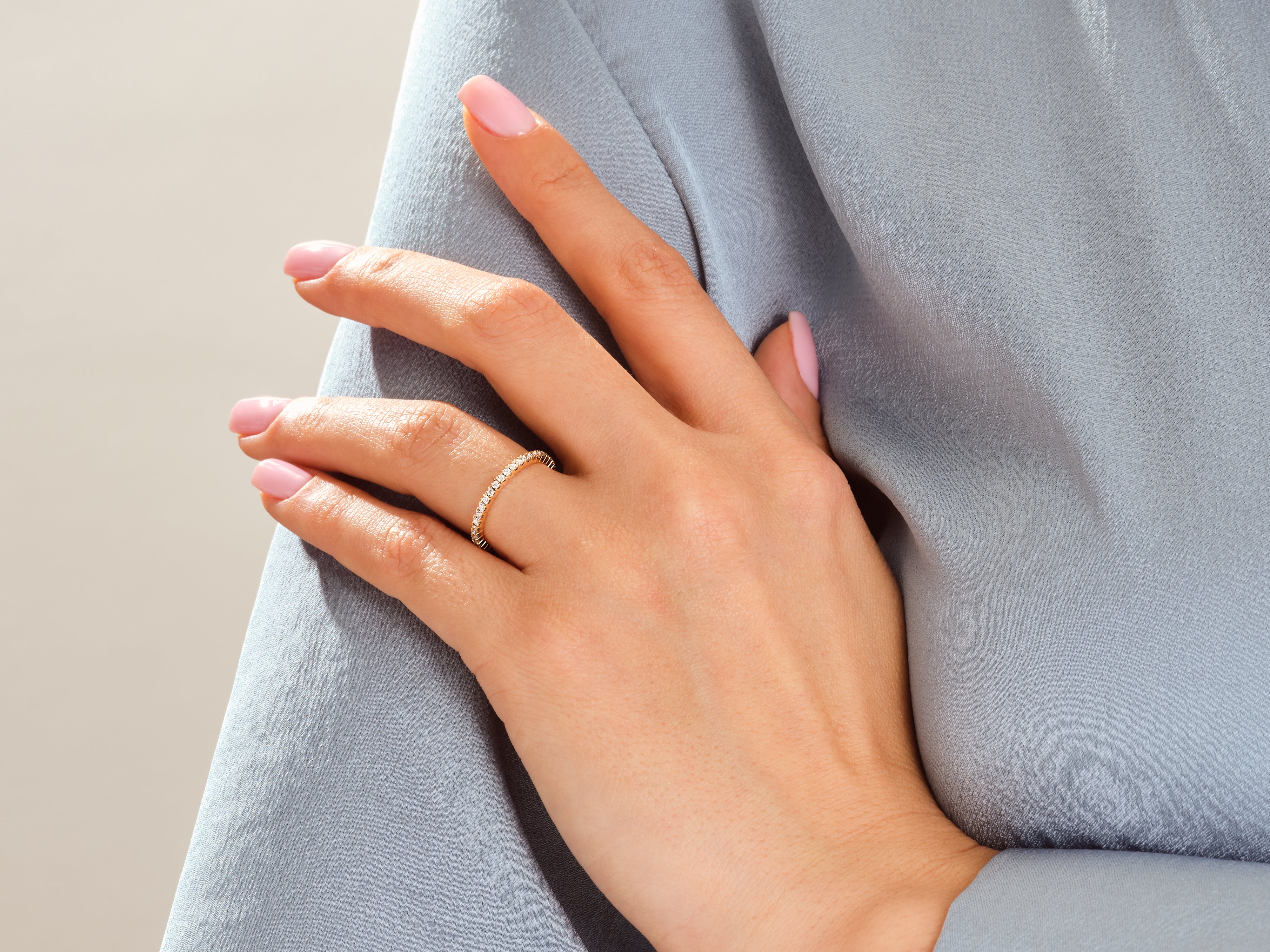 Diamond eternity ring on a woman's hand, jewelry product photography