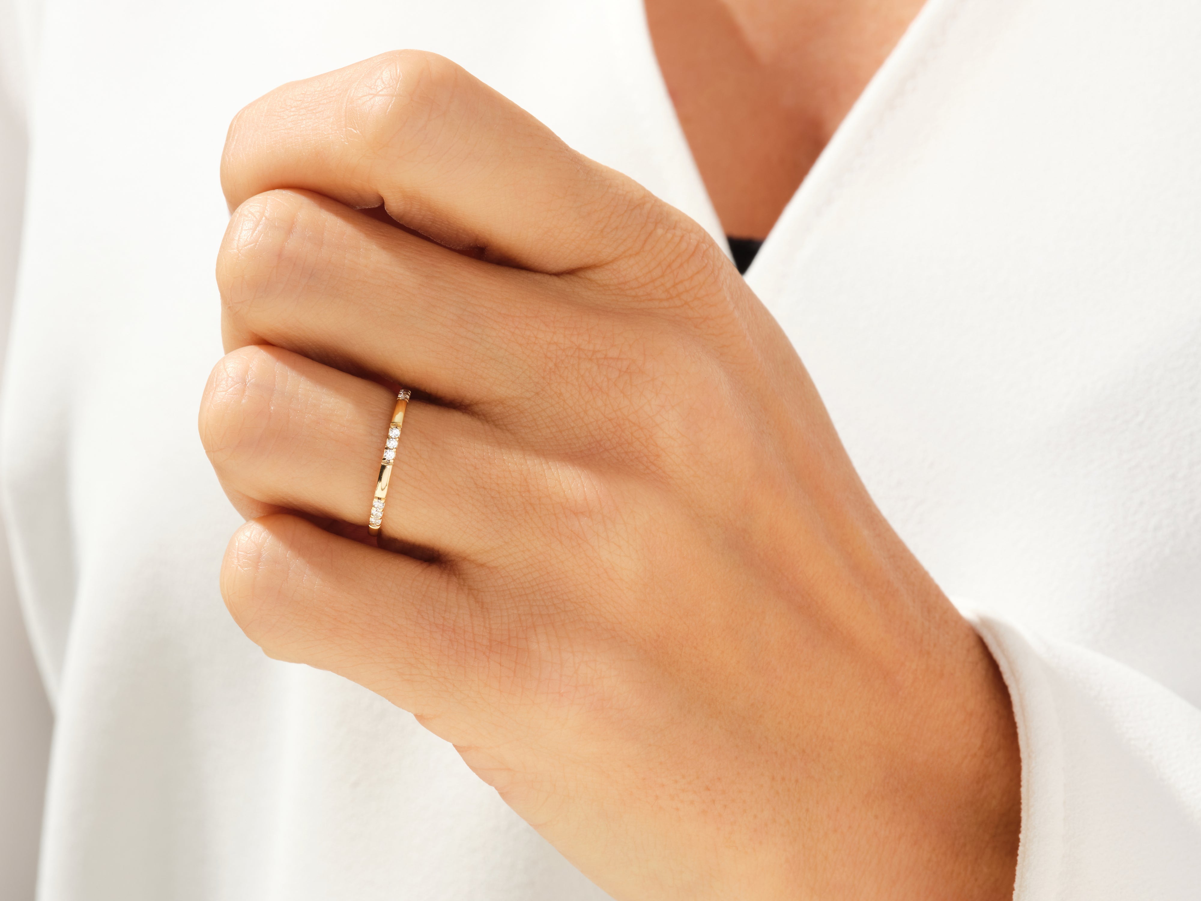 Gold diamond band ring on a woman's finger