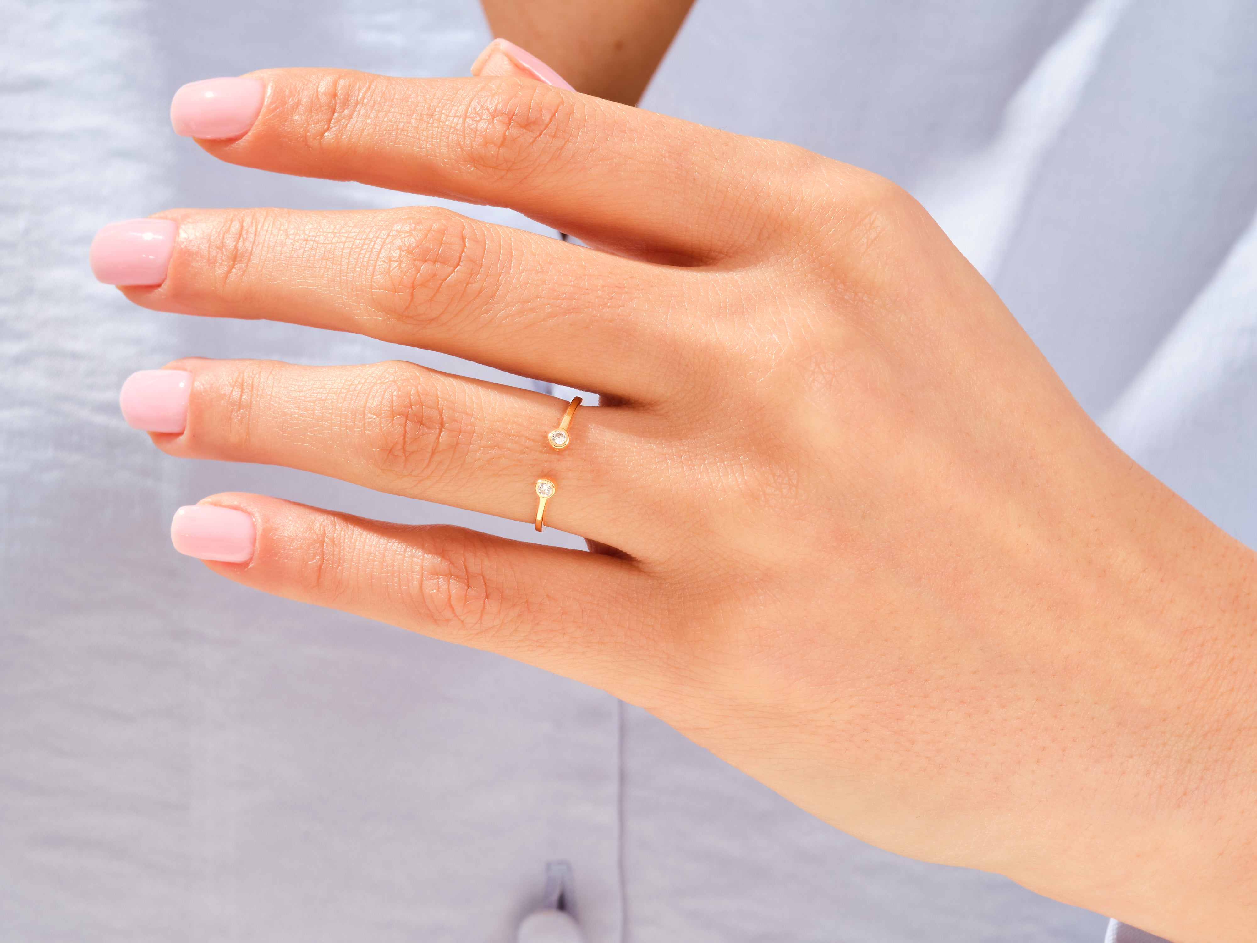 Gold diamond bypass ring on a woman's hand