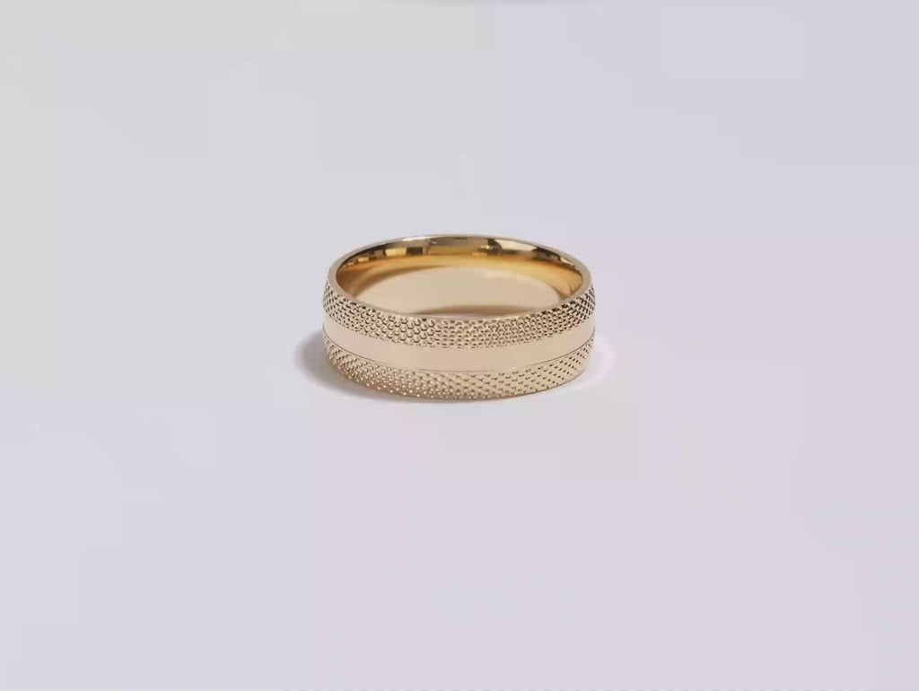 A video showing a yellow gold 7mm mid-beveled classic accents men's wedding band spinning on a white background.